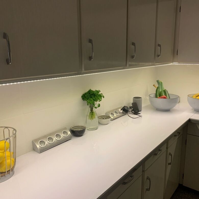 Spacious kitchen featuring white cabinetry, fresh fruit, and modern appliances in Arles-sur-Tech.