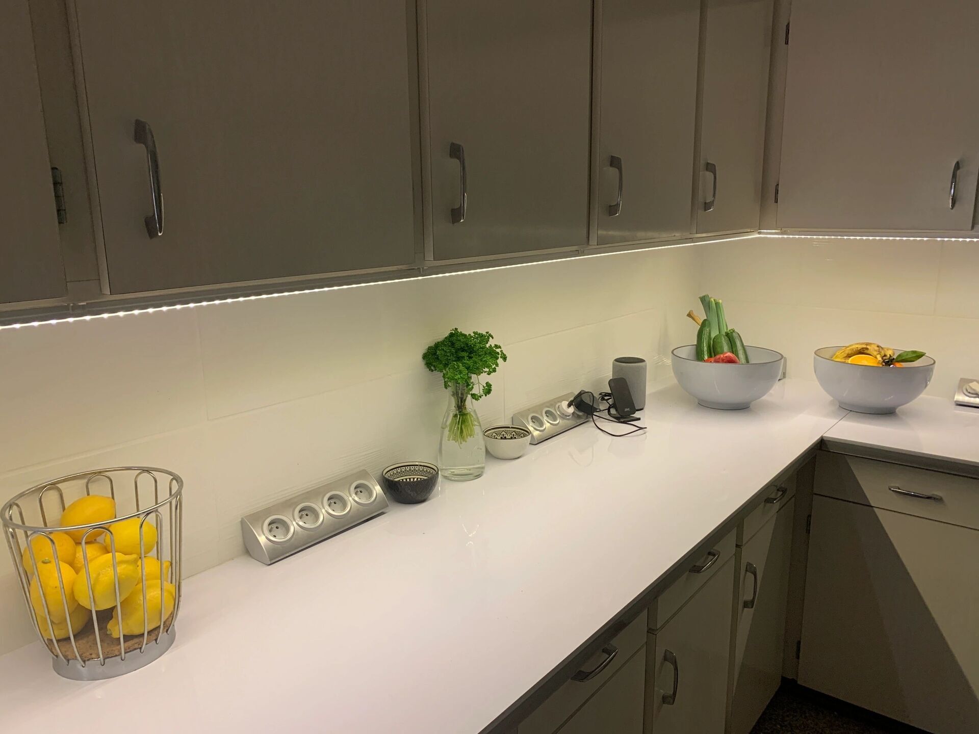 Spacious kitchen featuring white cabinetry, fresh fruit, and modern appliances in Arles-sur-Tech.