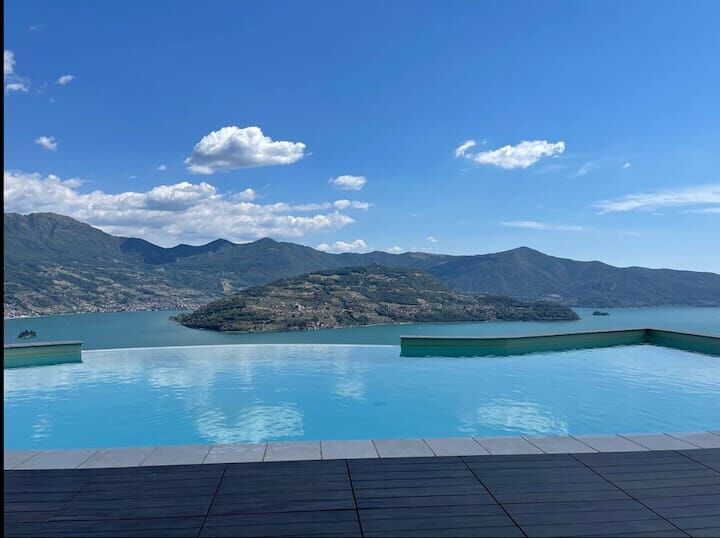 Stunning view of a mountain lake from a luxury duplex apartment in Spiglia.