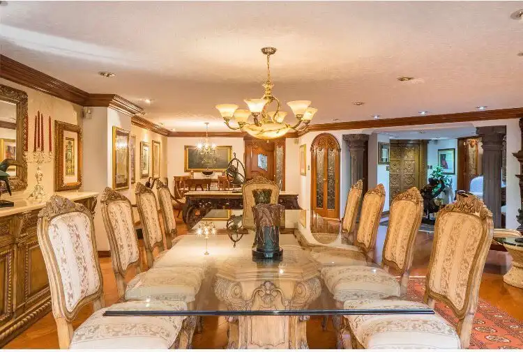 Elegant dining room in a luxury Mexico City apartment with ornate furniture and classic decor.