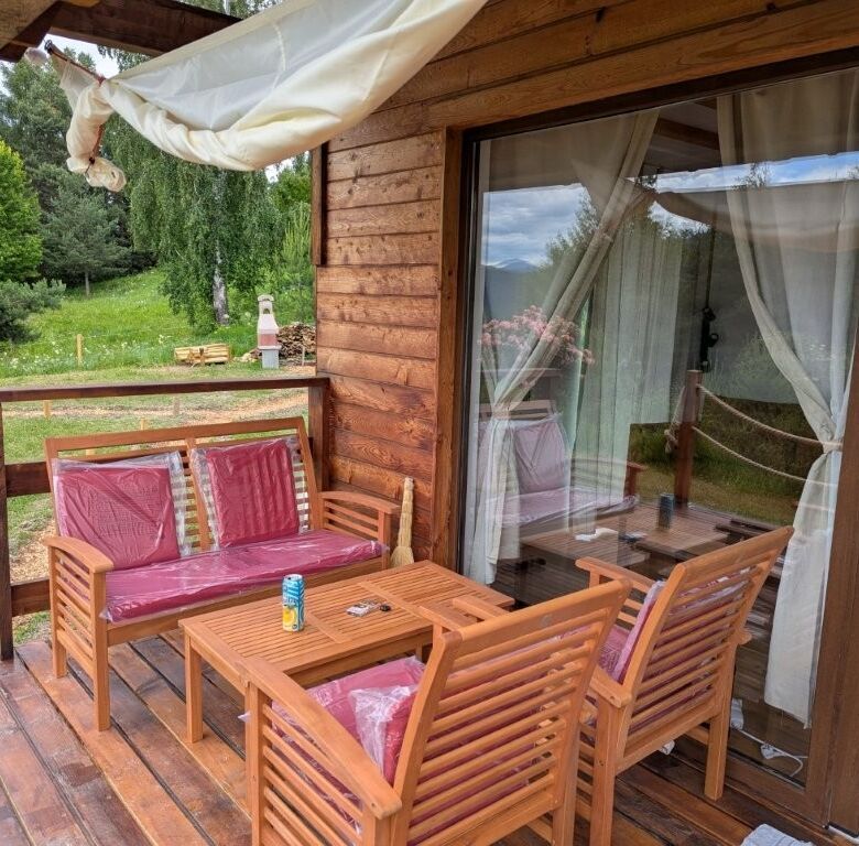 Charming 1-bed log cabin for sale with a wooden deck and garden views in Grozăvești.