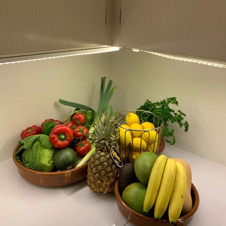 Fresh fruits and vegetables displayed in a cozy kitchen corner.