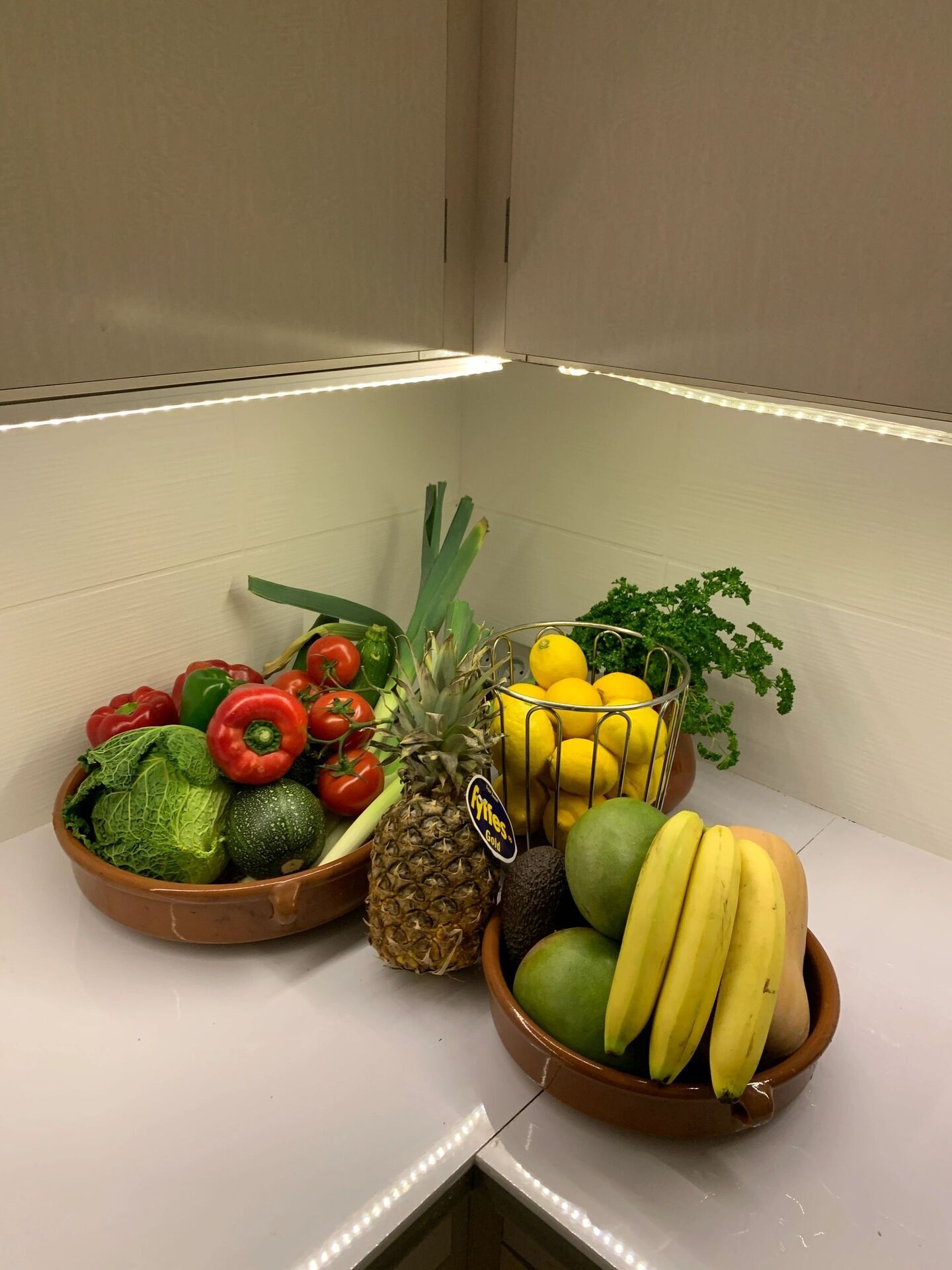 Fresh fruits and vegetables displayed in a cozy kitchen corner.