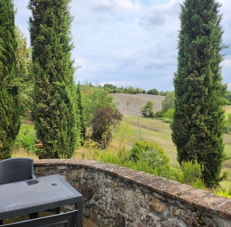 Elegant country villa with five bedrooms in Salsomaggiore Parma, surrounded by lush greenery and sce.