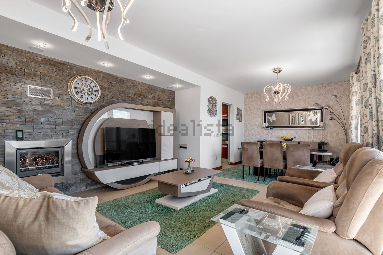 Luxury 3 Bed Villa For Sale In Santa Cruz Spacious living room with modern decor, fireplace, and entertainment center in Santa Cruz villa.