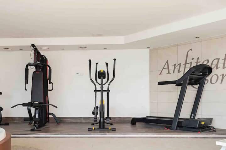 Modern gym equipment in a luxury duplex apartment fitness area.