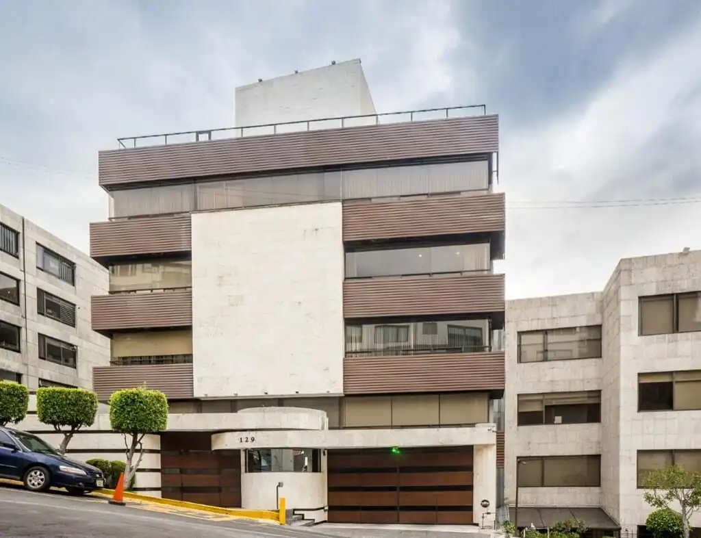 Apartment building in Mexico City with contemporary design and multiple balconies.