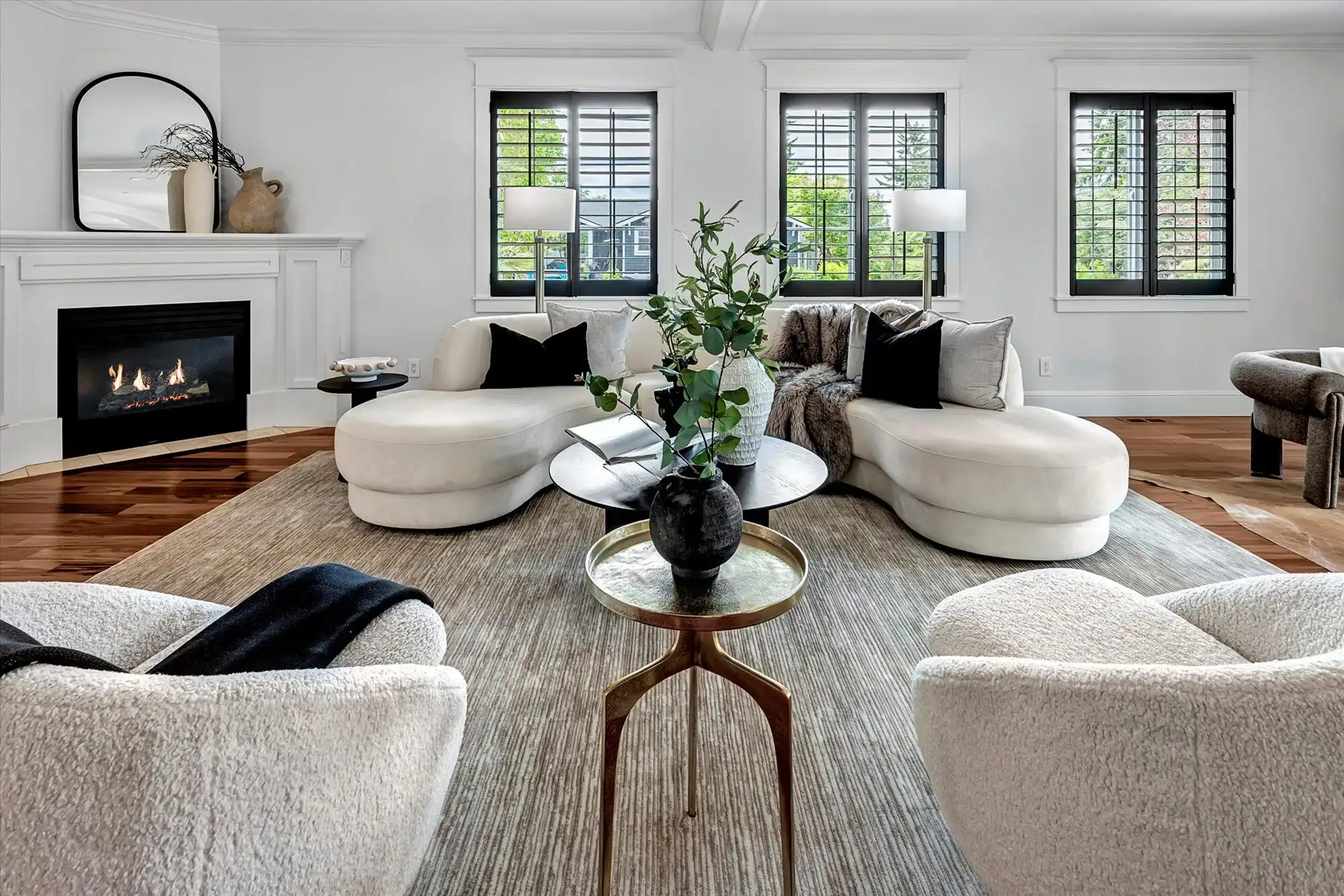 Elegant modern living room with lake views and stylish decor.
