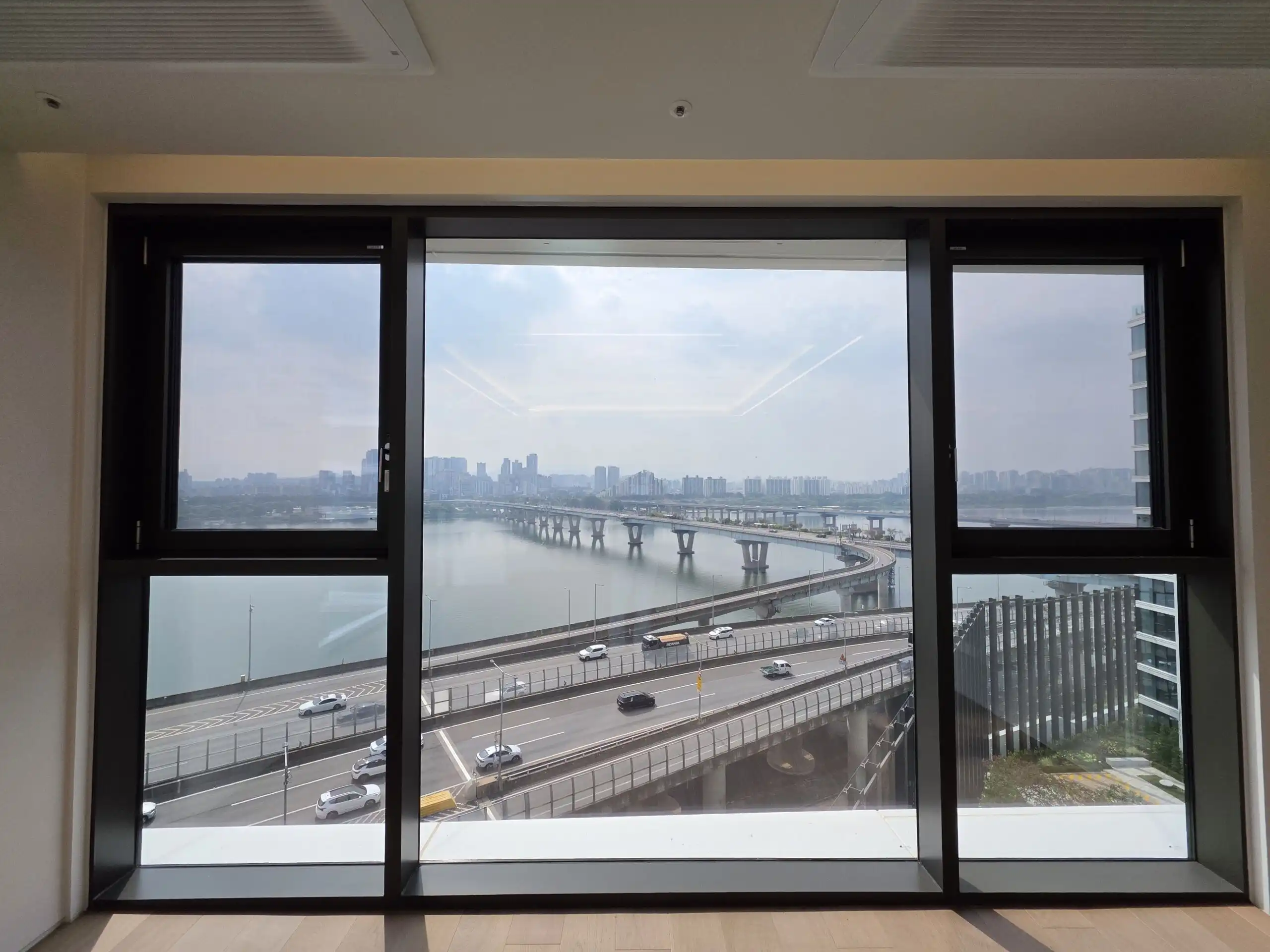 Luxury apartment with panoramic river and city skyline views in Seoul, South Korea.