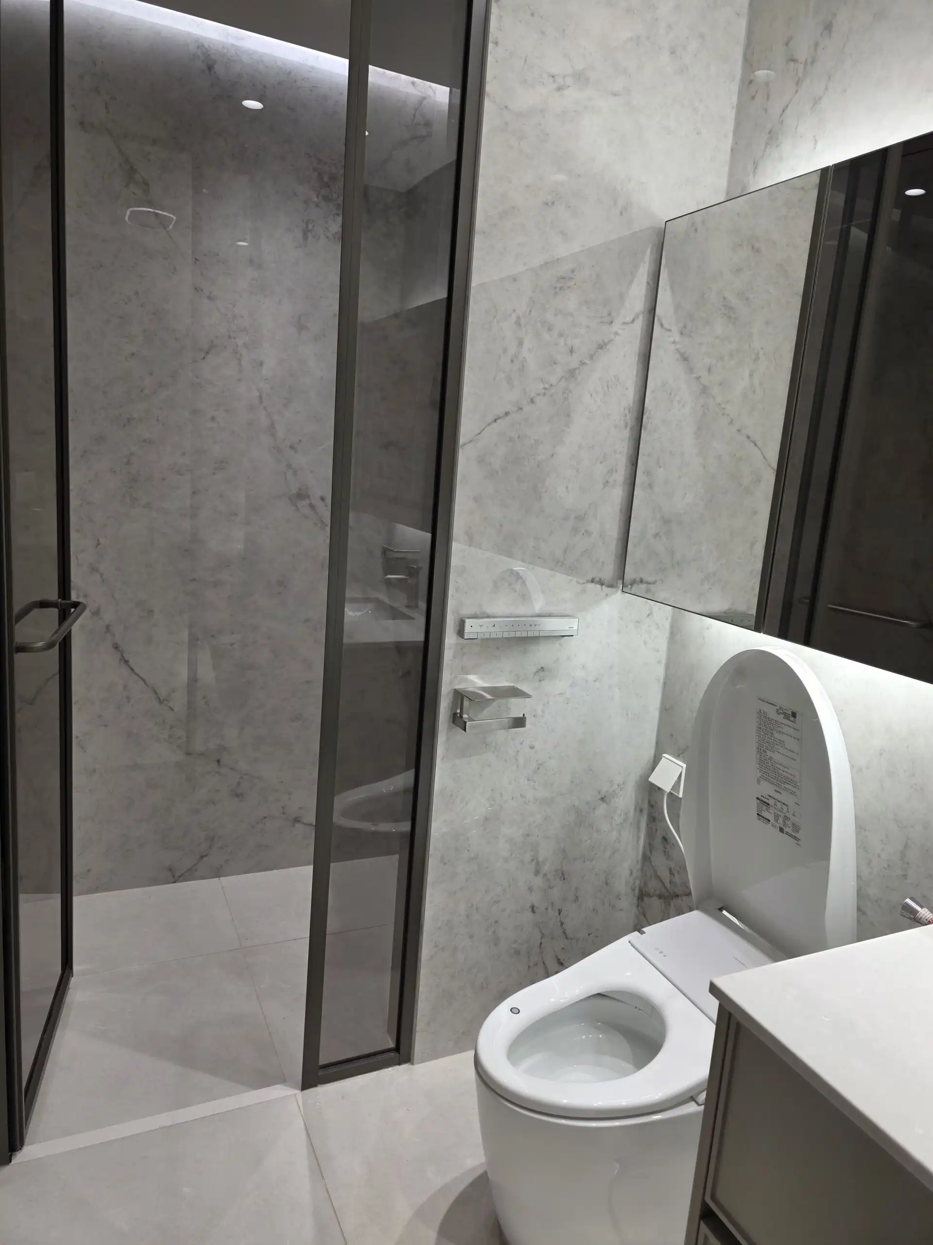 Modern bathroom with marble walls and sleek fixtures in Seoul, South Korea.