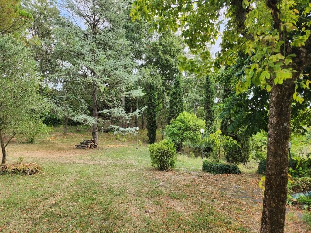 Luxury 5 Bed Country Villa for Sale Spacious garden view of a lush green country villa in Salsomaggiore Parma.