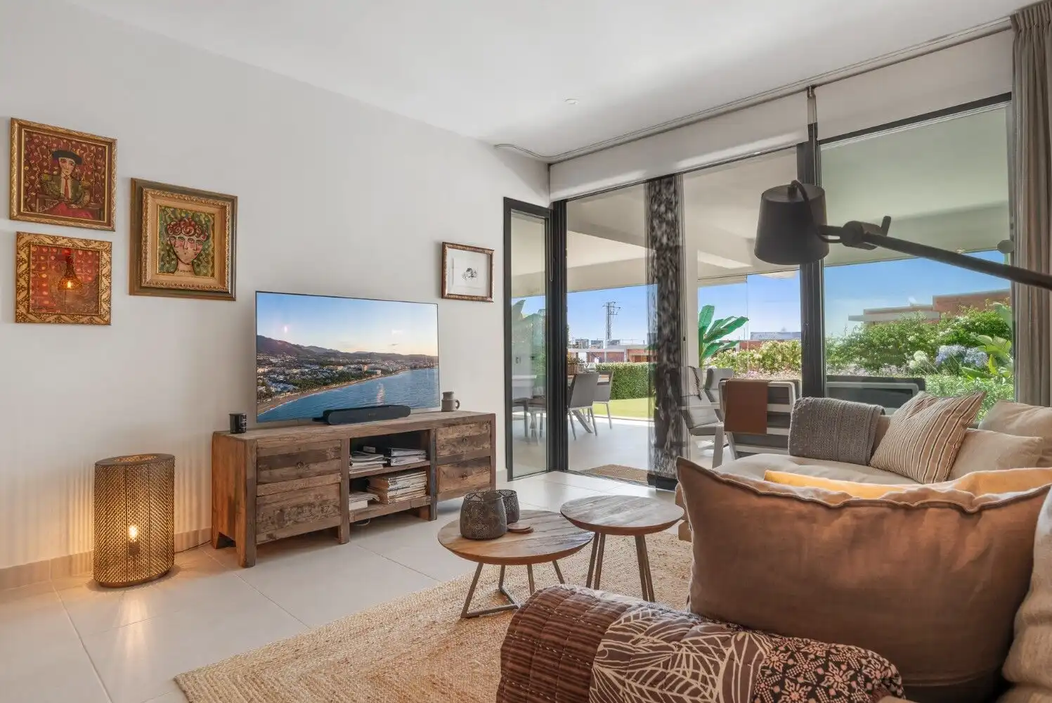 Spacious living room with large sliding glass doors opening to a balcony with sea views. Contemporar.