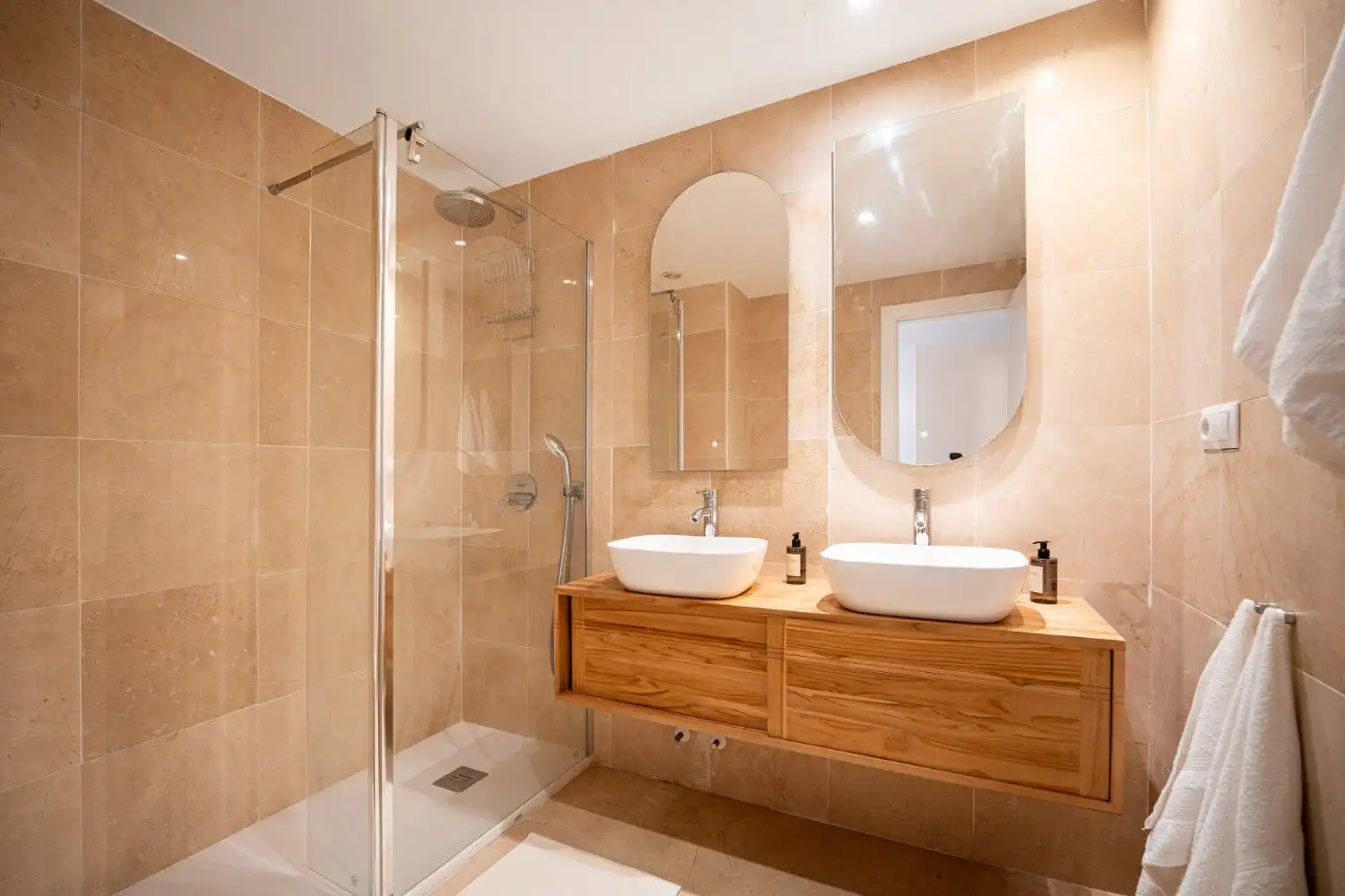 Beautifully renovated bathroom with dual sinks and modern fixtures in Marbella East apartment.