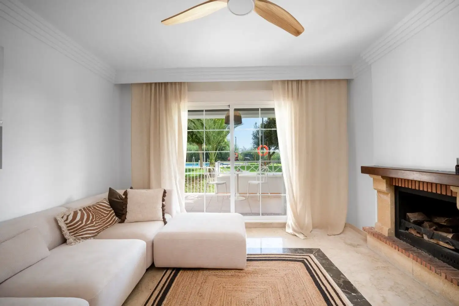 Bright living room with large sliding glass doors and balcony view.