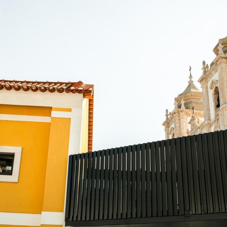 Charming boutique hotel exterior in Leiria, Portugal with historic architecture and vibrant yellow f.