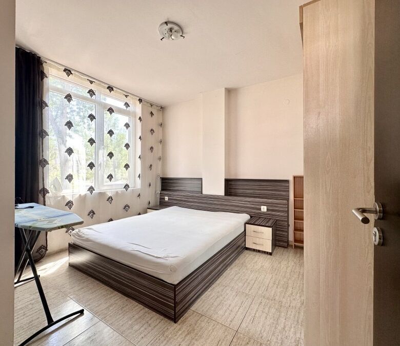 Apartment with a pool view, spacious bedroom, and natural light in Sunny Beach, Bulgaria.