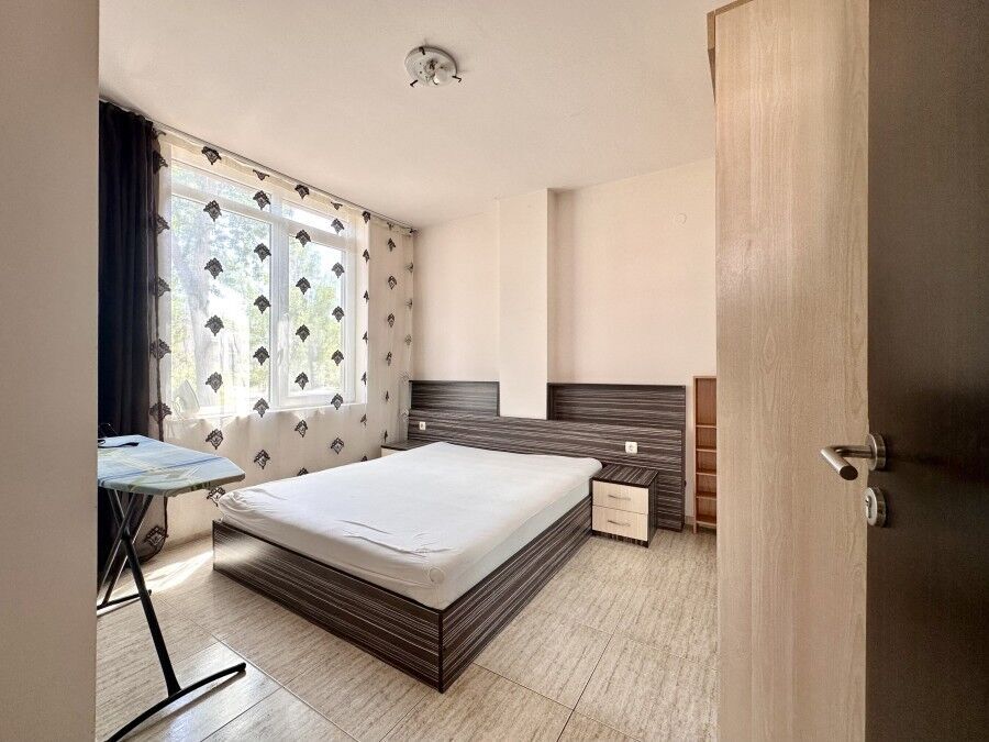 Apartment with a pool view, spacious bedroom, and natural light in Sunny Beach, Bulgaria.