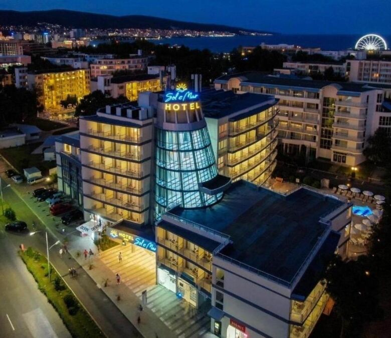 Brightly lit Sol E Mar hotel near Sunny Beach coastline.