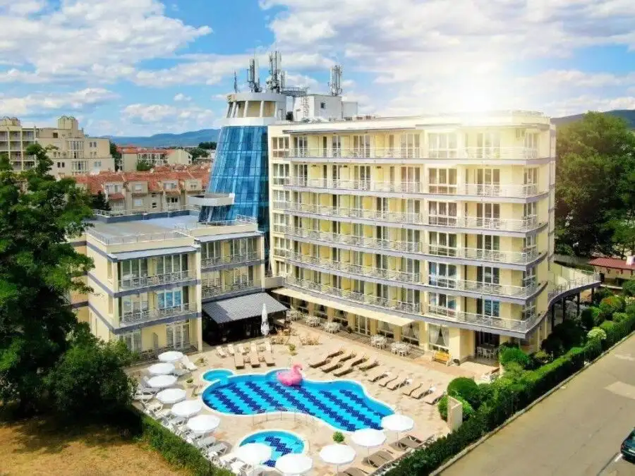 Apartment building near the beach with a swimming pool and sun loungers in Sunny Beach, Bulgaria.