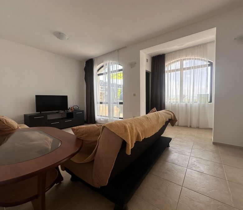 Bright living room with large windows and pool view in Nessebar View complex.