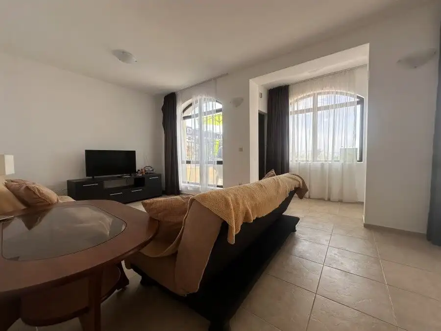 Bright living room with large windows and pool view in Nessebar View complex.