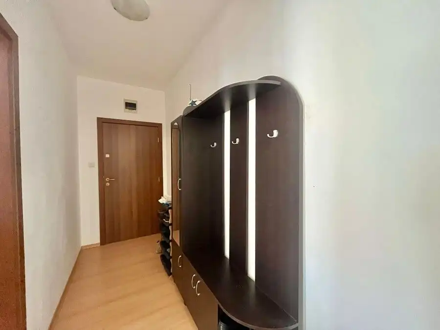 Modern fully furnished 2-bedroom apartment hallway with wardrobe and shoe storage, near the coast.