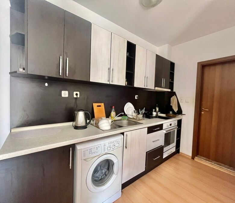 Modern fully furnished kitchen in a 2-bedroom apartment near the coast.