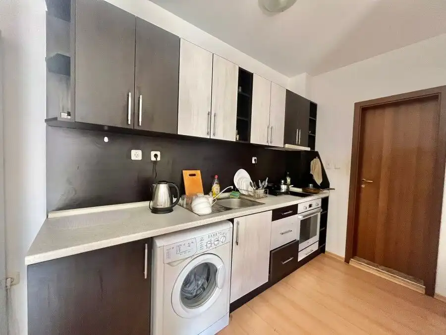 Modern fully furnished kitchen in a 2-bedroom apartment near the coast.
