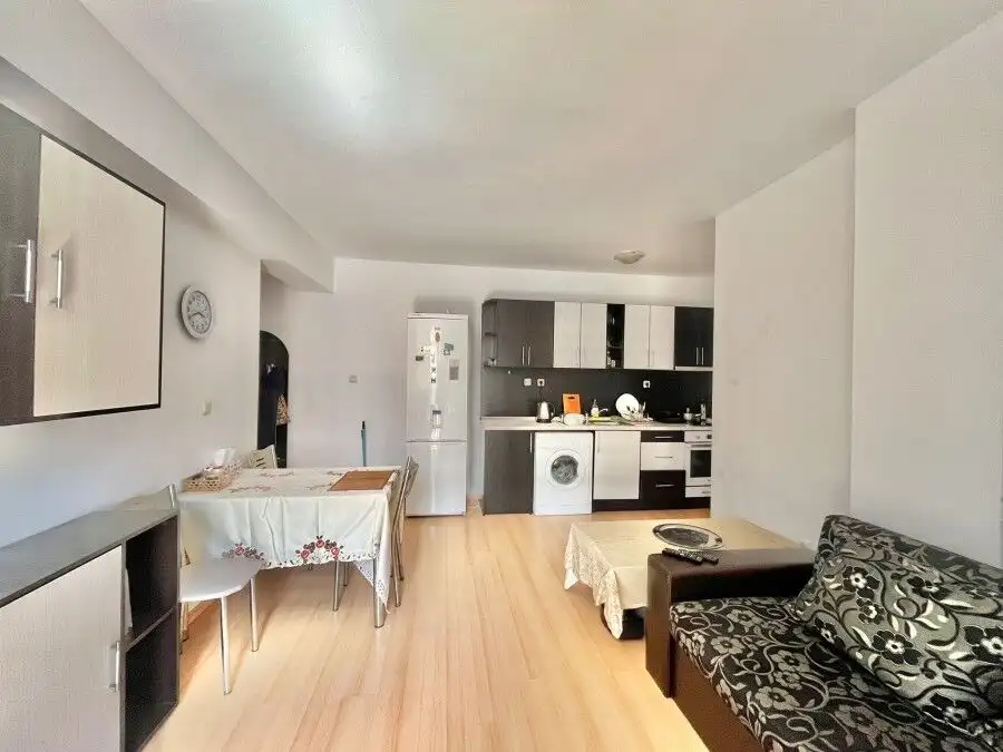 Modern 2-bedroom fully furnished apartment near the sea, 73 sq.m., sunny day, open-plan living area.