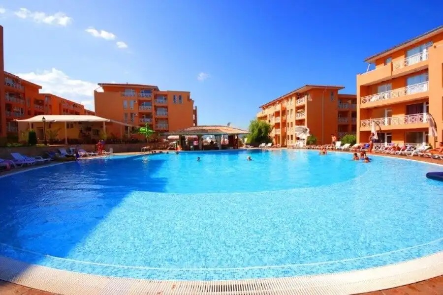 Apartment complex with pool, terraces, and panoramic views.