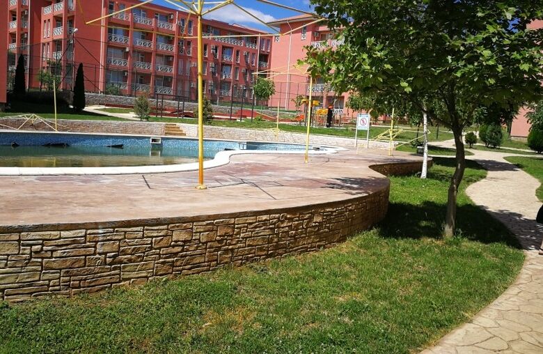 Outdoor pool and green spaces at a contemporary residential community.
