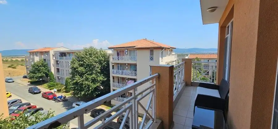 Balcony with panoramic views and outdoor seating in a modern apartment.