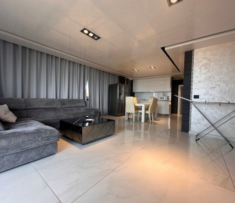 Sea view luxury penthouse with spacious living area and modern decor.