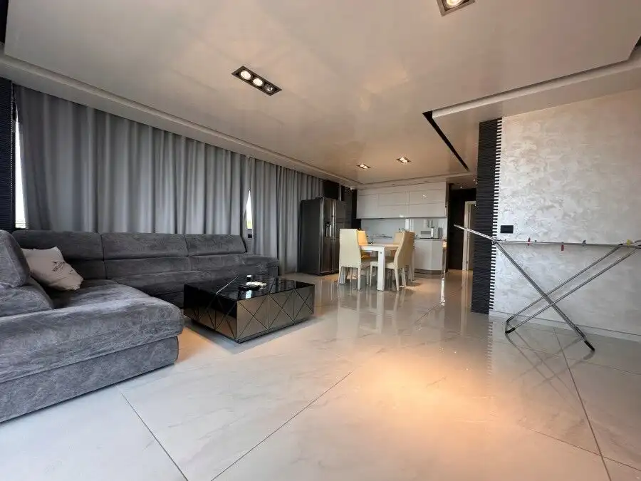 Sea view luxury penthouse with spacious living area and modern decor.
