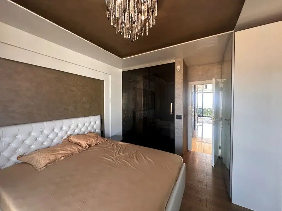 Penthouse bedroom with sea views, modern decor, and access to a spacious terrace in Sveti Vlas.