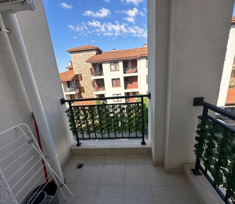 Balcony view of neighboring apartments and blue sky in Ravda, Bulgaria.