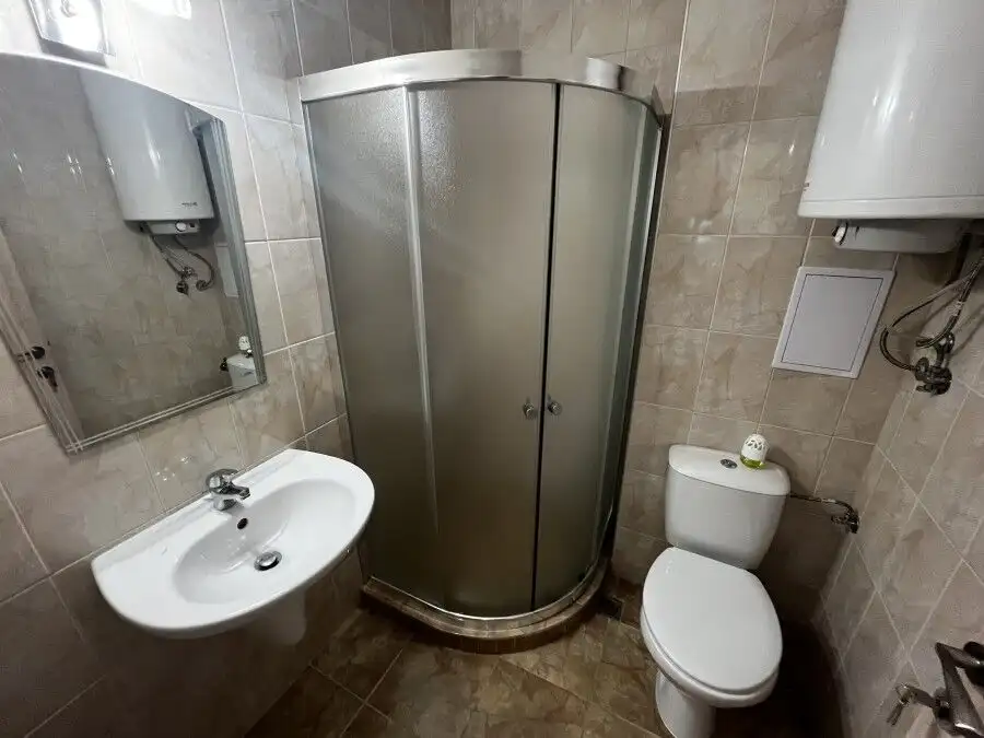 Compact bathroom with shower, toilet, and sink in Apollon apartments, Ravda.