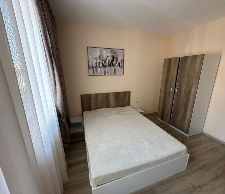 Modern studio apartment in Apollon, Ravda, with a comfortable bed and wardrobe.