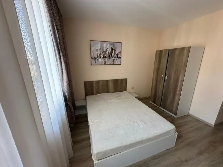 Modern studio apartment in Apollon, Ravda, with a comfortable bed and wardrobe.