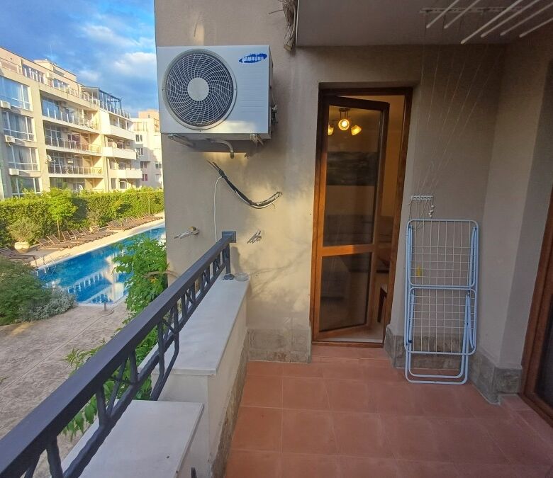 Balcony overlooking the pool at Cascadas Family Resort, Sunny Beach, with air conditioning unit and.