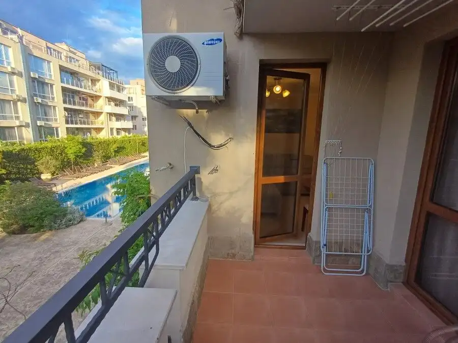 Balcony overlooking the pool at Cascadas Family Resort, Sunny Beach, with air conditioning unit and.