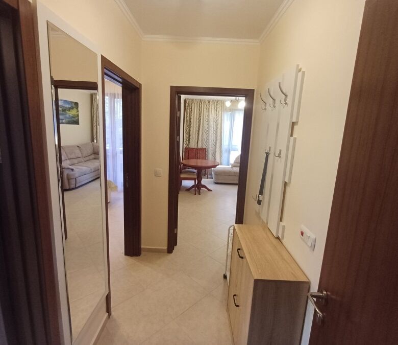 Bright hallway leading to living area with pool view in Cascadas Resort.