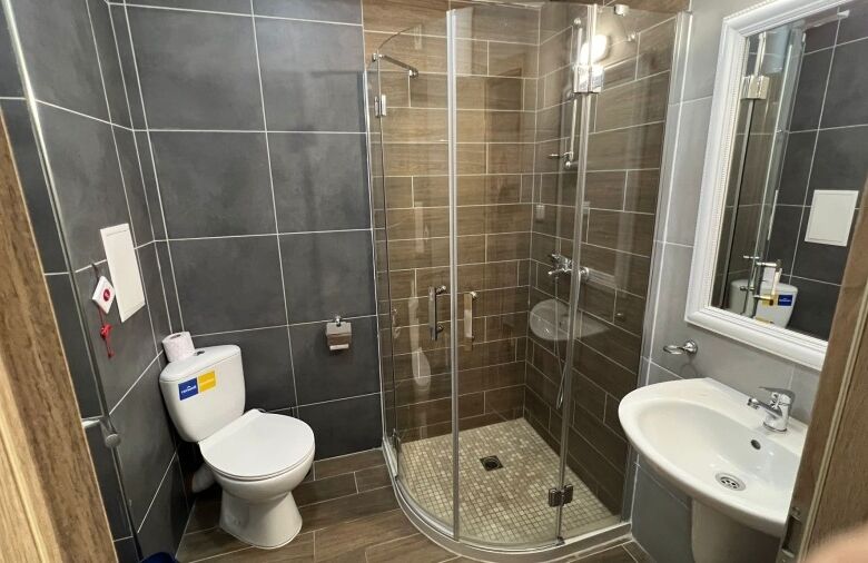 Modern bathroom with shower and new fixtures in a compact studio at Cascadas Family Resort.