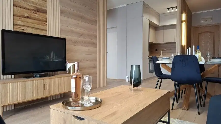 Bright, stylish living space with contemporary furniture and wooden accents.