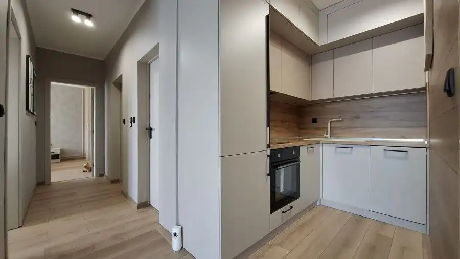 Modern kitchen with sleek cabinetry and appliances in a spacious Sunny Beach apartment.
