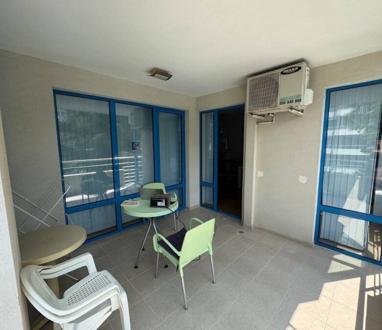 Bright balcony with pool view in Sunny Beach apartment.