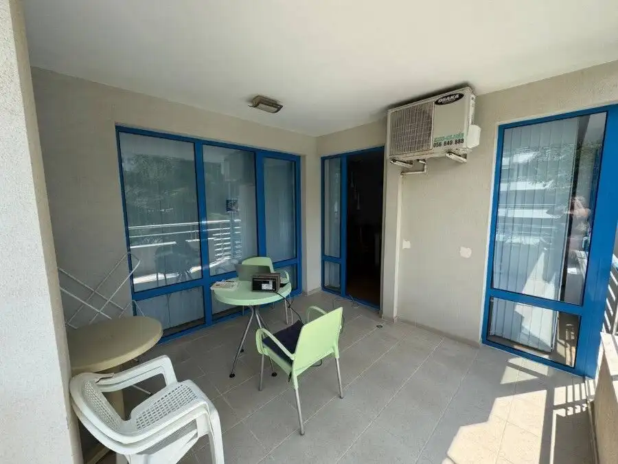 Bright balcony with pool view in Sunny Beach apartment.