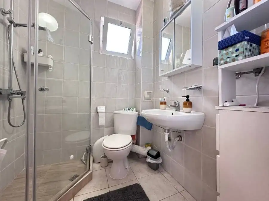 Bright bathroom with shower, toilet, and sink in Robinson Gardens, Sunny Beach.
