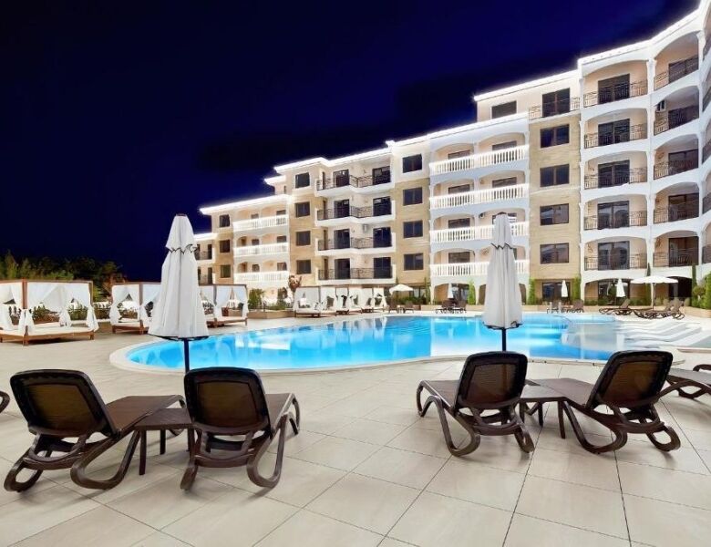 Pool area with sun loungers and umbrellas at Valencia Gardens complex.