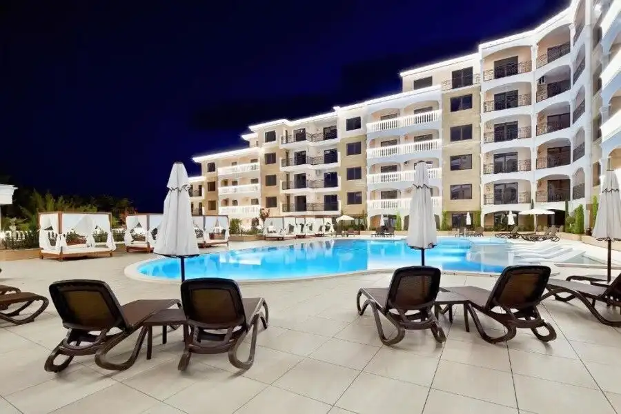 Pool area with sun loungers and umbrellas at Valencia Gardens complex.